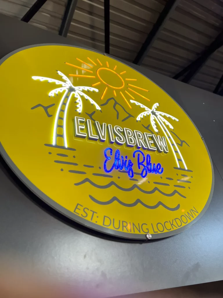 Bright yellow Elvis Brew sign with "Elvis Blue" logo, established during lockdown.